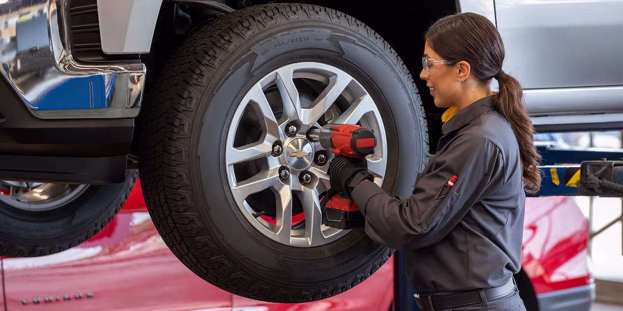 A Chevy parts technician putting on a new tire