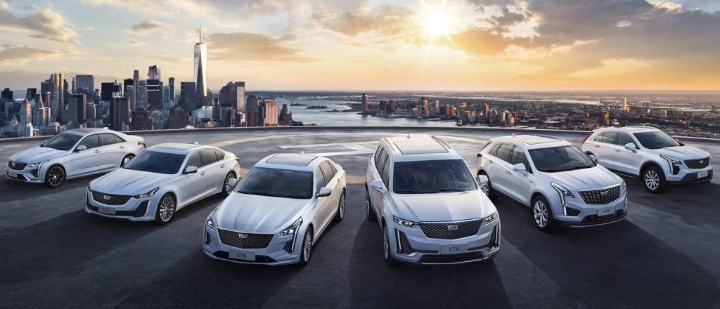 Cadillac Vehicles in front of a city scape