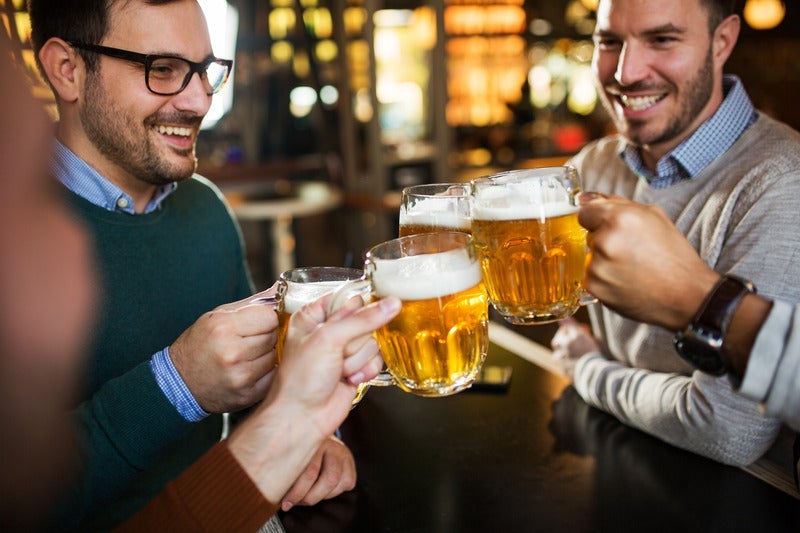 beer glasses raised for a cheers
