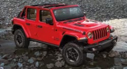Jeep Wrangler driving over rocks
