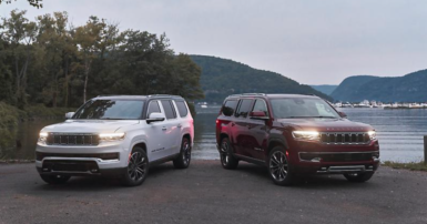 two 2022 Jeep Wagoneers parked in front of a lake
