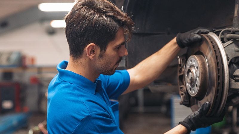 technician changing brakes