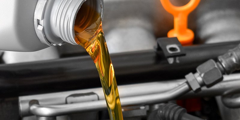 oil pouring into an engine