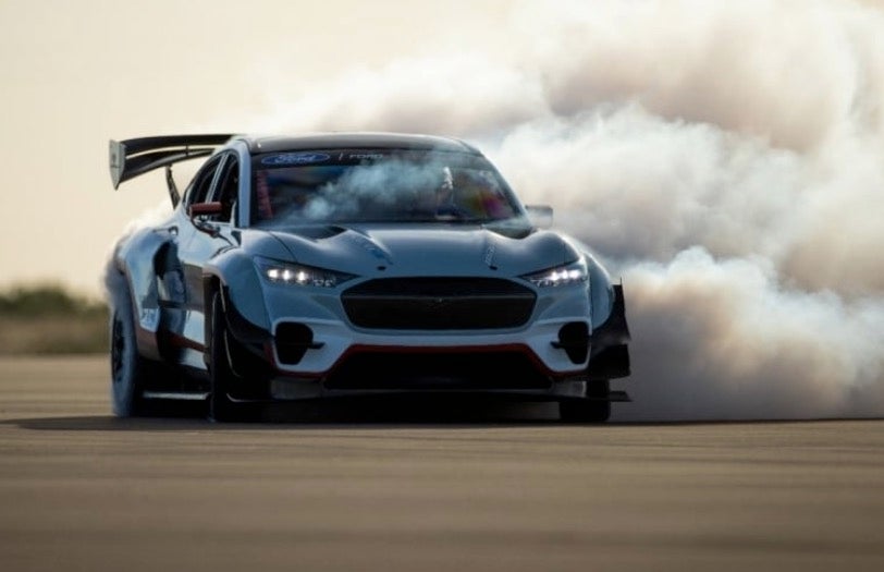 Ford Mustang Mach-E 1400 burning out its tires on a race track