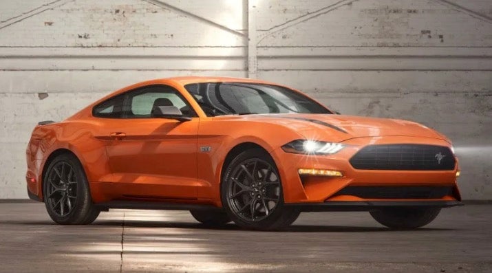 Ford Mustang in orange in a parking garage