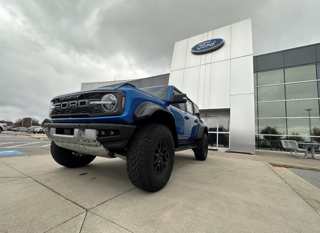Ford Bronco parked in front of dealership building