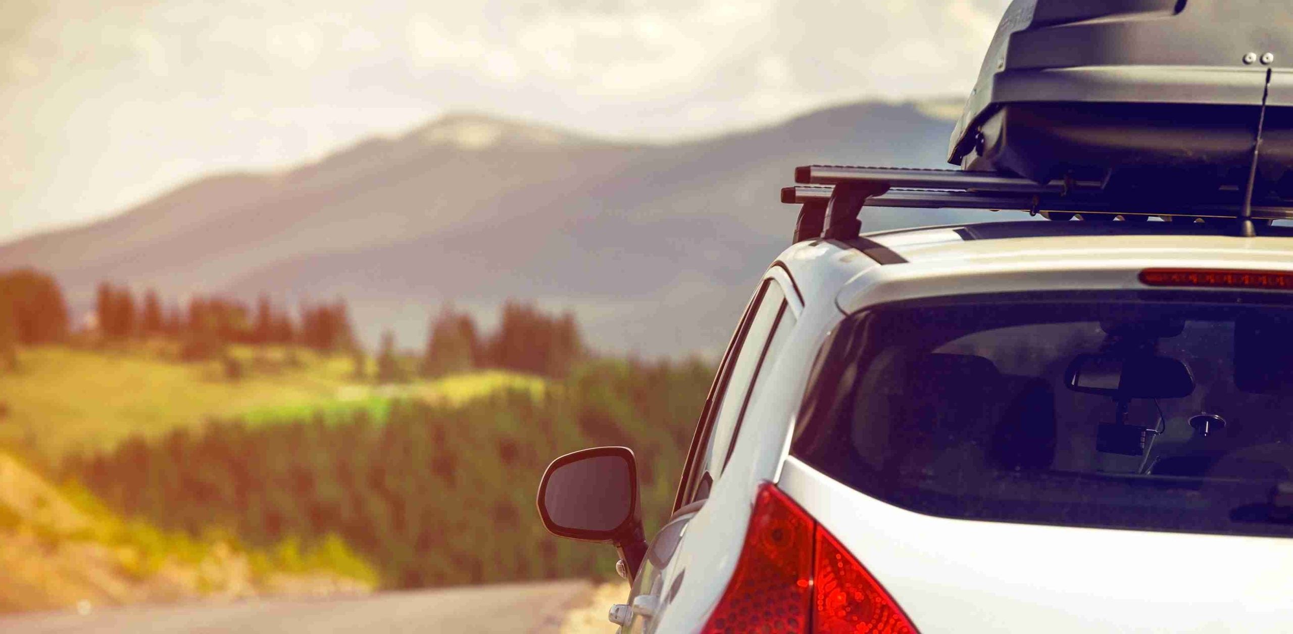 car on a road trip with luggage on roof