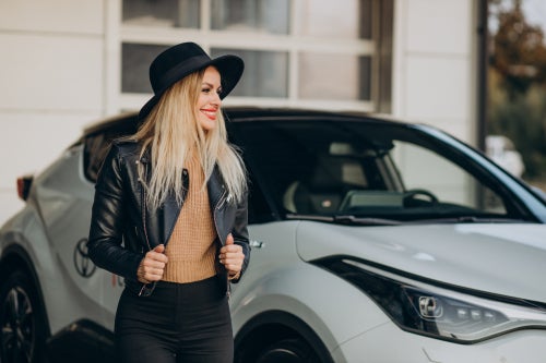 Woman standing in front of a car