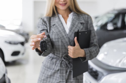 Person holding out a set of car keys