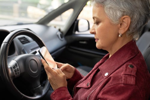 person behind the wheel of a car