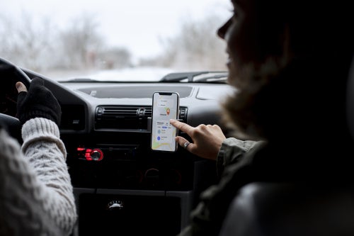 People in a car looking at a phone