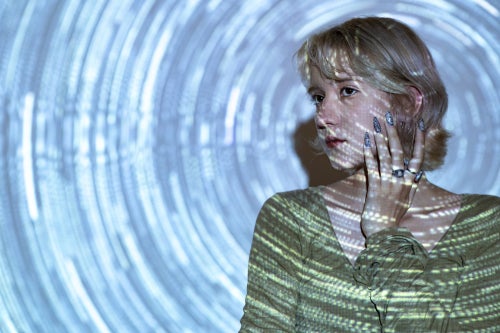 Woman with projector image on her face