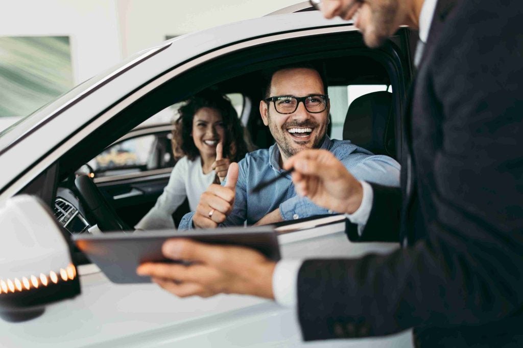 People smiling in a car