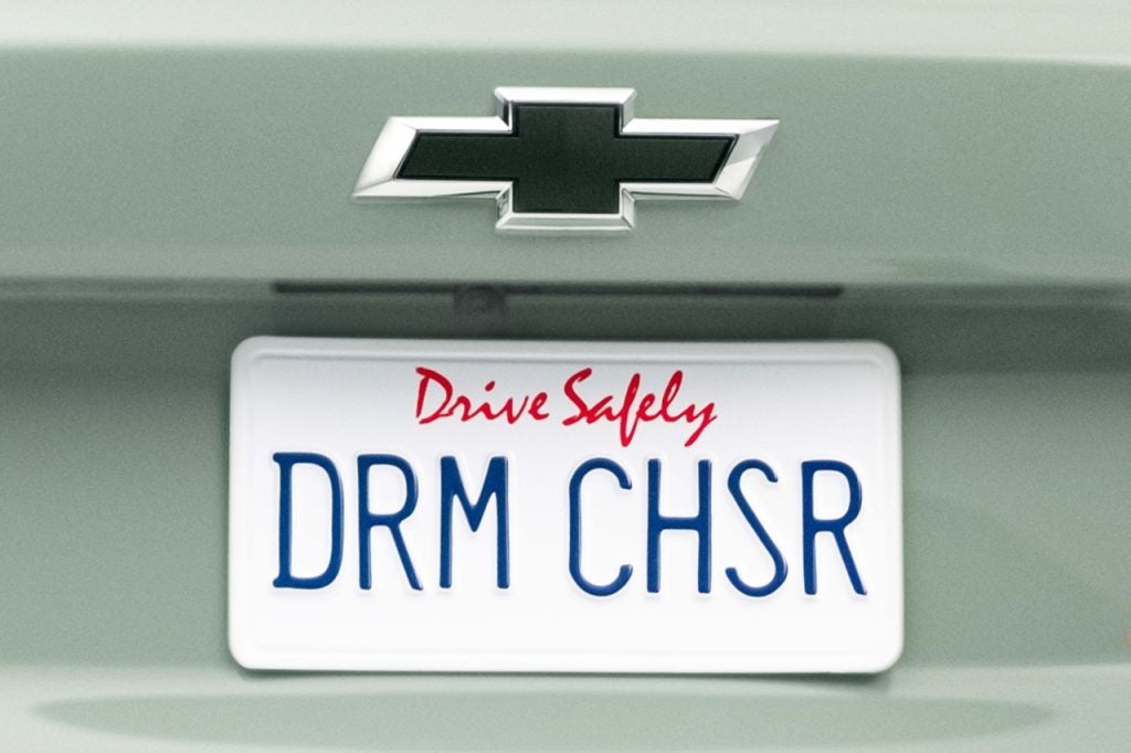 Close up of license plate that says “DRM CHSR” on Chevrolet Trax ACTIV in Cacti Green. Preproduction model shown. Actual production model may vary. Available Spring 2023. Cacti Green exterior color 