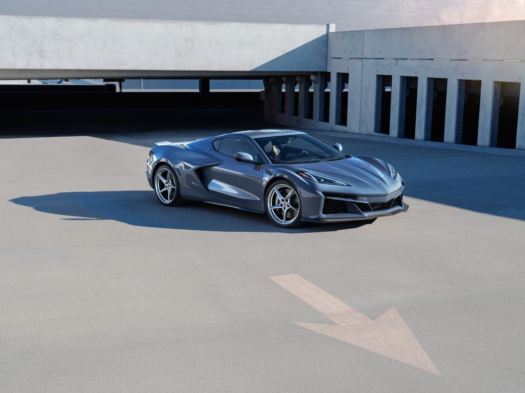 Passenger side front 3/4 view of 2024 Chevrolet Corvette E-Ray 3LZ coupe in Seawolf Gray parked in a parking garage. Pre-production model shown. 