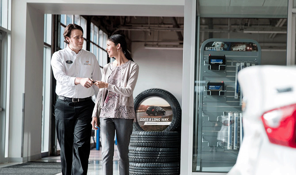 Man and woman at a car dealership