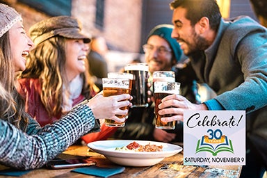 Friendly guys approaching happy girls at brewery pub outdoor on winter time - Friendship concept with young people having drunk fun together drinking beer at happy hour