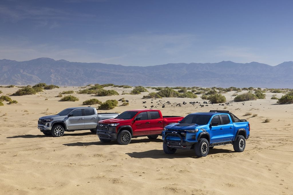 Group shot of Colorado Z71, Trail Boss and ZR2 (R-L) all shown from front 3/4 view in desert and mountain scene.