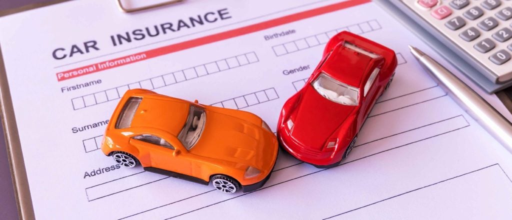 toy cars on insurance documents