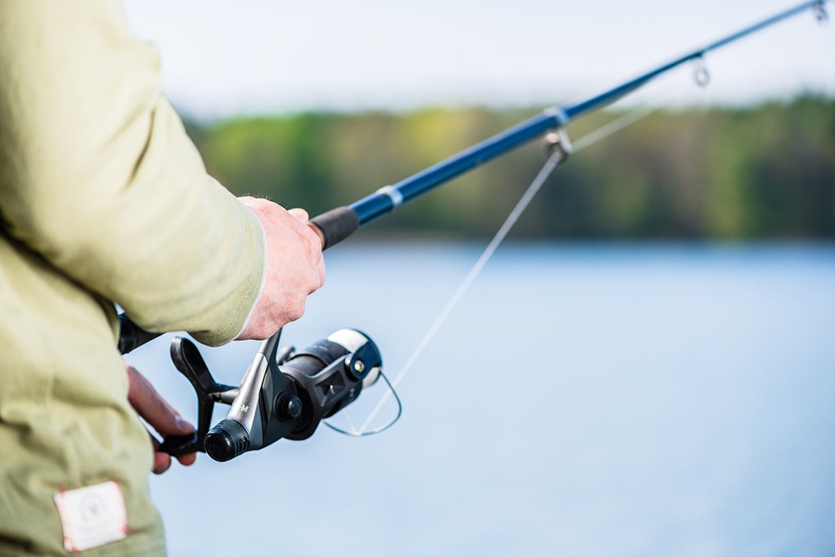 Man,Fishing,With,Angle,At,Lake,,Crop,Shot