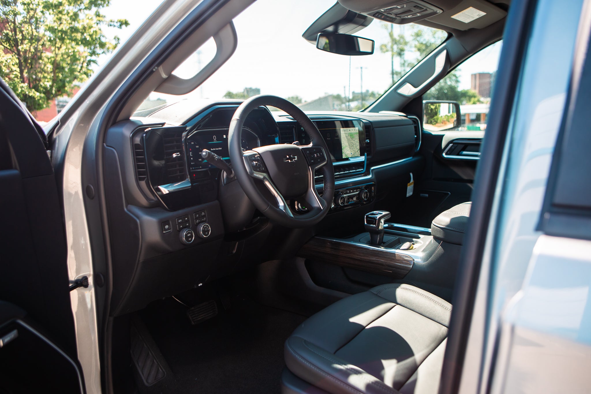 Interior view of a modern Chevrolet truck with black leather seats and a digital dashboard.