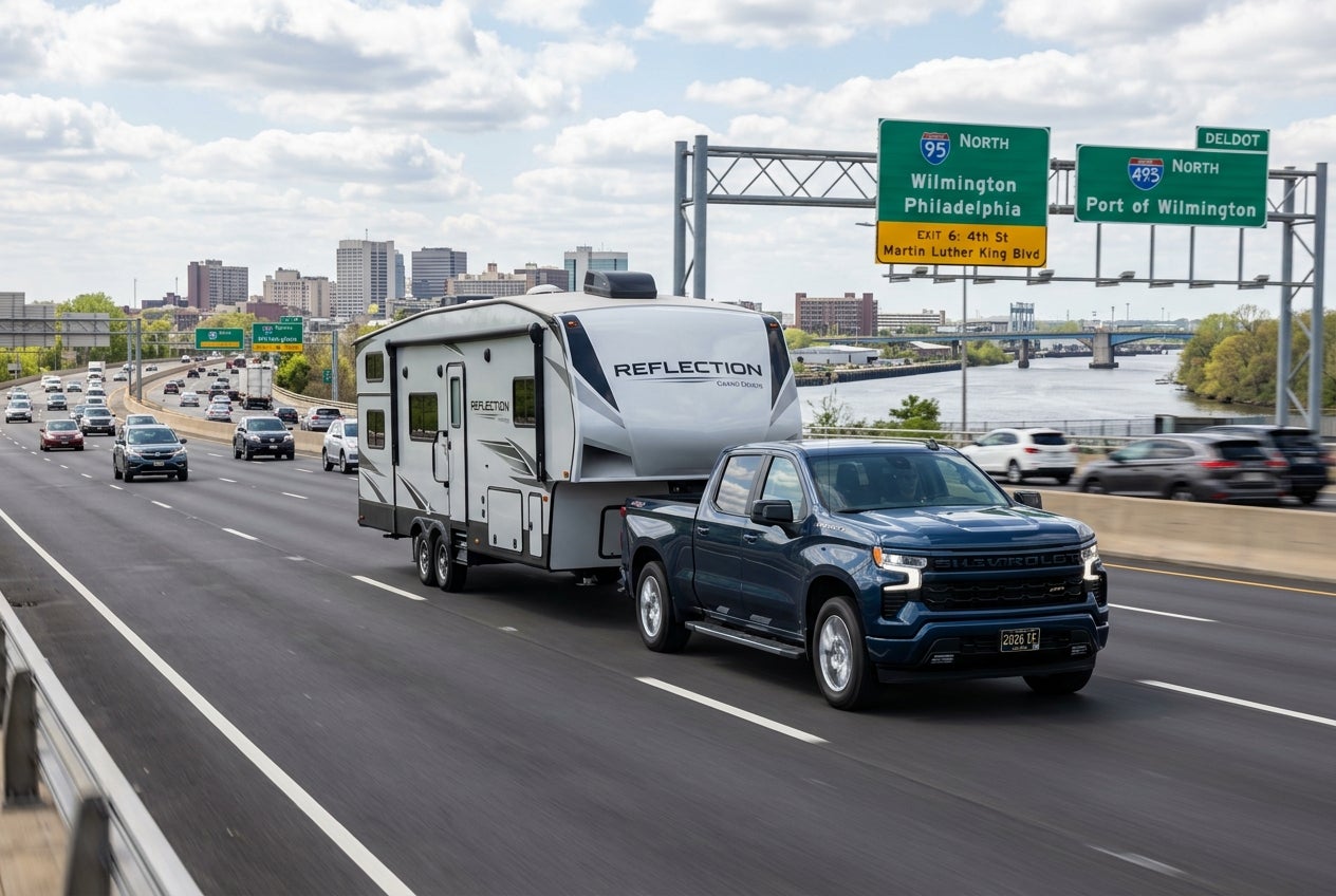 AI generated: 2026 Silverado 1500 towing a large trailer on a highway in Wilmington Delaware