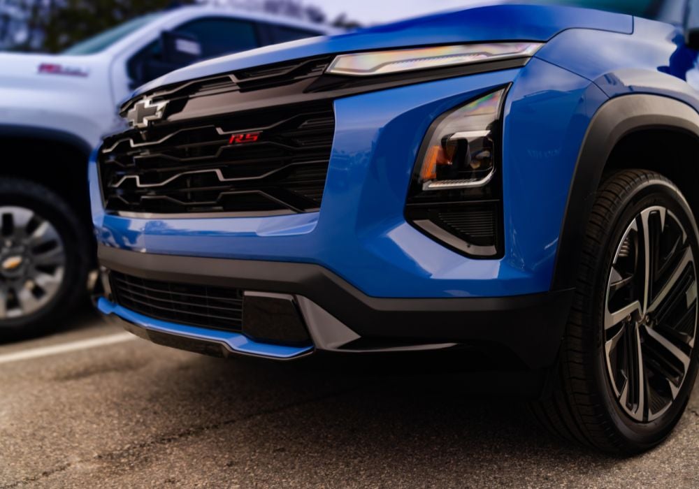 Close up of the front grille of a 2026 Chevrolet Equinox. The SUV is blue.