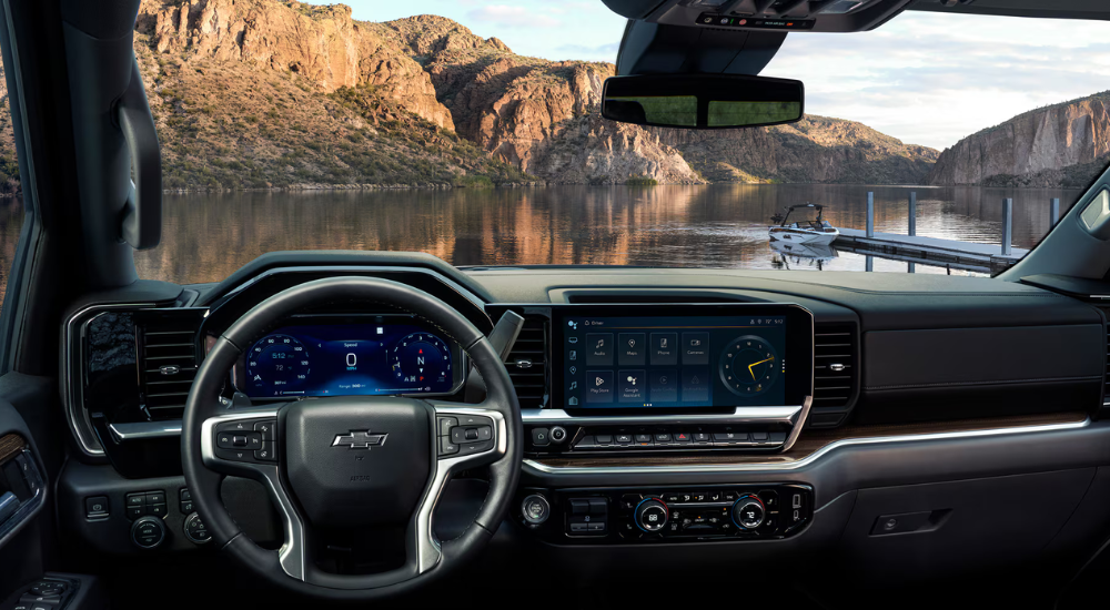 Black interior showing steering wheel, digital gauge cluster, and infotainment system on a 2026 Chevy Silverado 1500 for sale near Fair Oaks Ranch.
