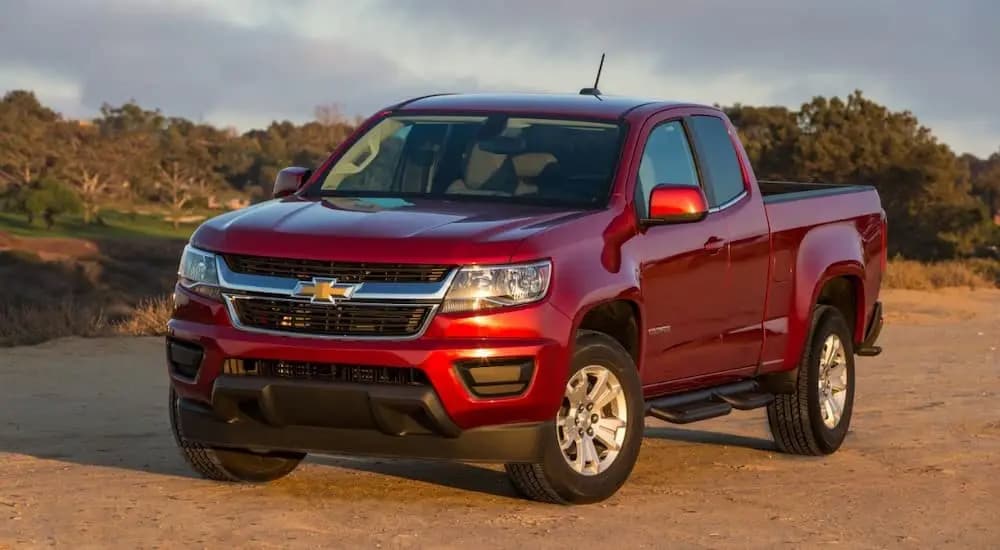 Red 2017 Chevy Colorado parked on dirt.