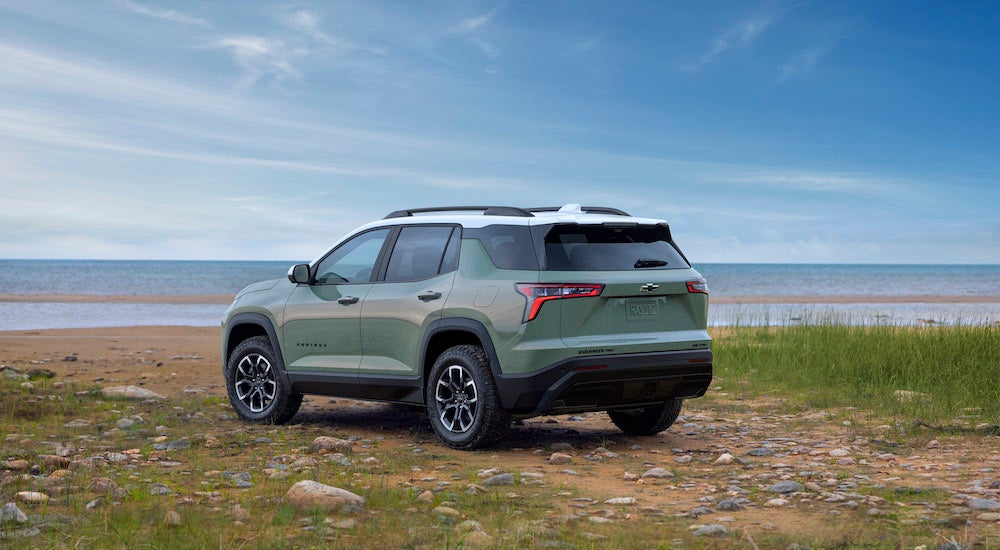 A green 2025 Chevy Equinox ACTIV from the rear at an angle.