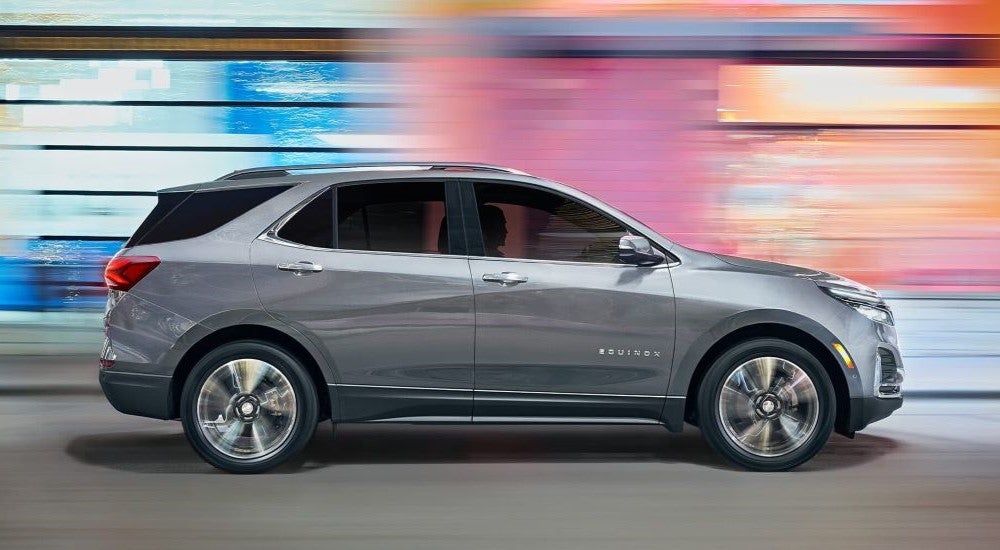 A silver 2023 Chevy Equinox driving to look at SUVs for sale in Castroville,