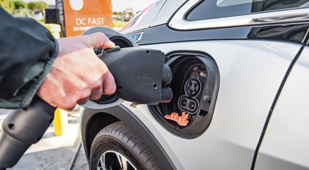 A person charging a 2022 Chevy Bolt EV.