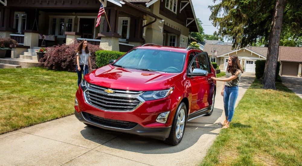 A red 2018 Chevy Equinox parked on a driveway.