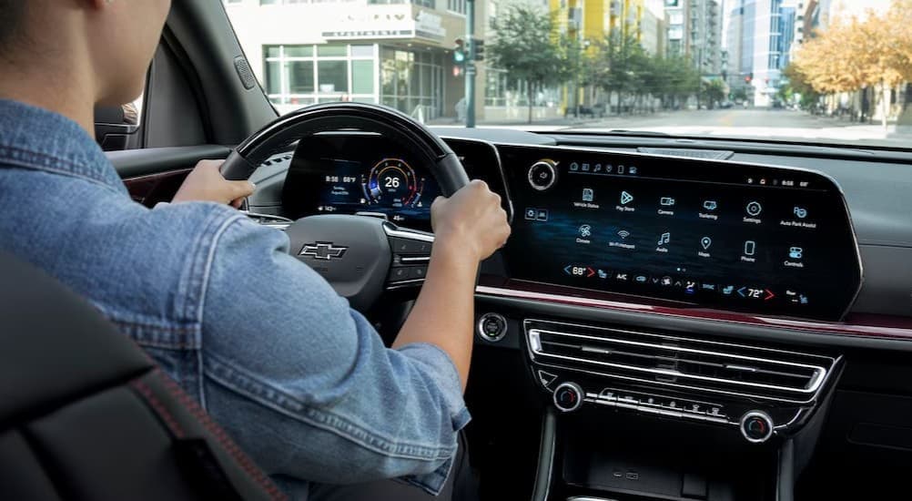 A person driving in a 2026 Chevy Traverse.