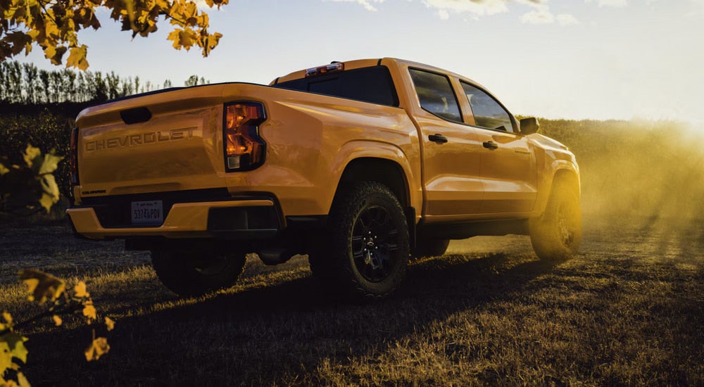 Yellow 2026 Chevy Colorado parked in an open field on a sunny day