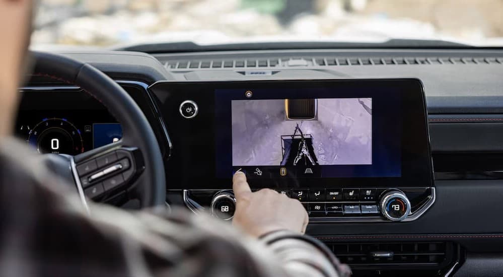A person using the infotainment screen in a 2025 Chevy Colorado.