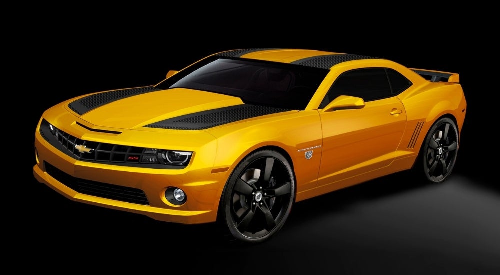 A yellow 2012 Chevy Camaro Transformers 3 Special Edition against a dark background.