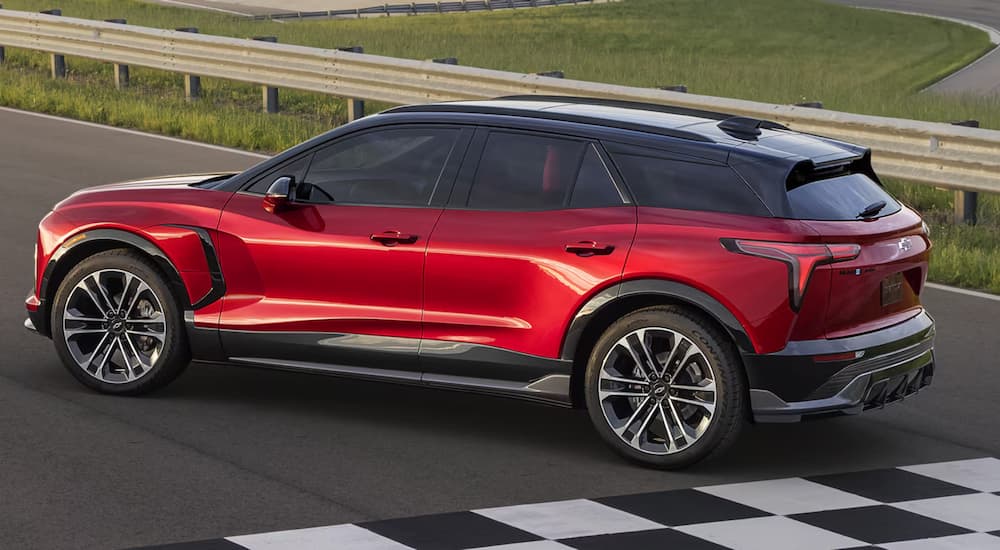 Rear view of a red 2025 Chevy Blazer EV parked on a race track.