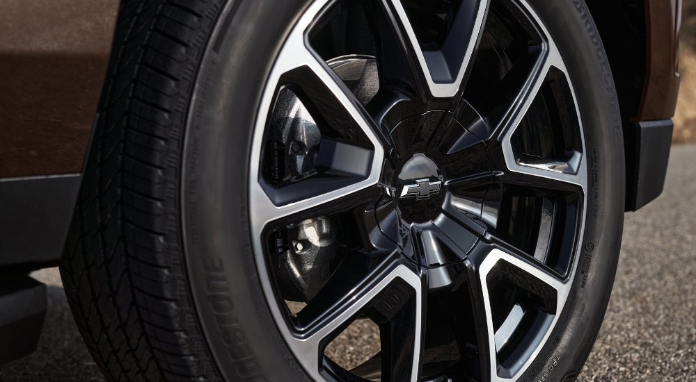 Black and silver wheel on a brown 2022 Chevy Tahoe.