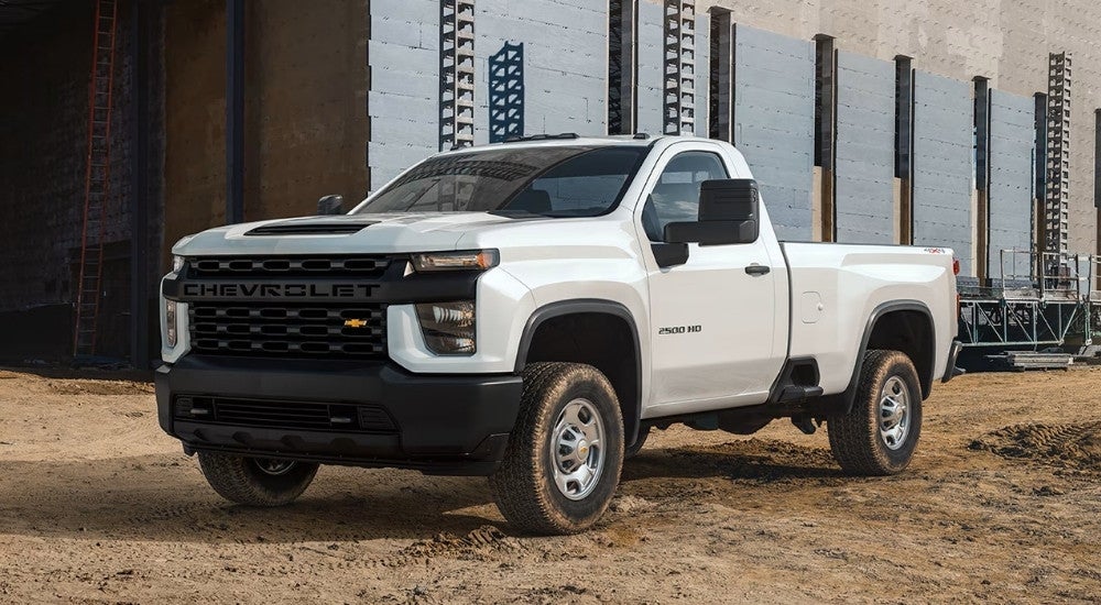 A white 2021 Chevy Silverado 2500 HD WT on a construction site.