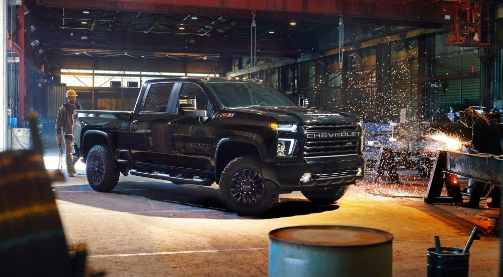 A black 2022 Chevy Silverado 2500 HD on a worksite.