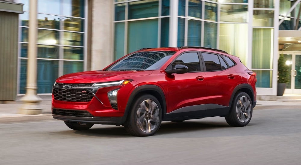 A red 2026 Chevy Trax 2RS driving in a city