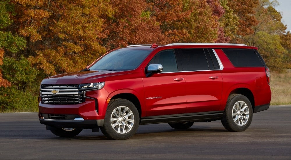 A red 2022 Chevy Suburban from the side.