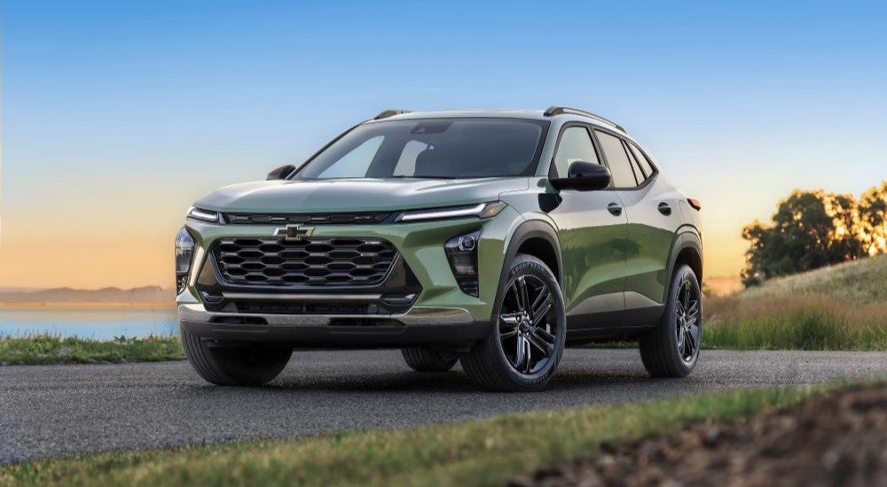 Green 2026 Chevy Trax ACTIV parked near a lake