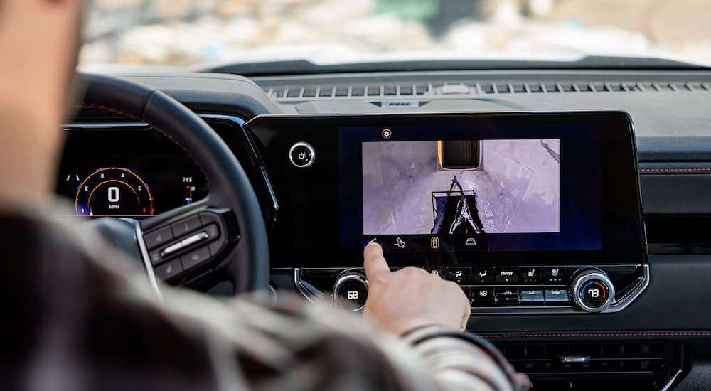 A man using the backup camera display on a 2025 Chevy Colorado