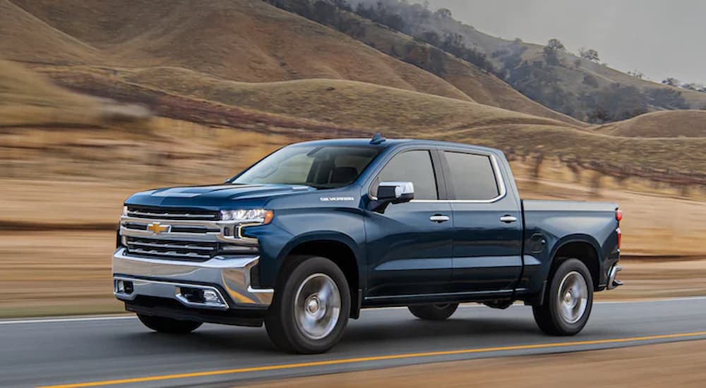 Blue 2022 Chevy Silverado 1500 Limited driving on an open road.