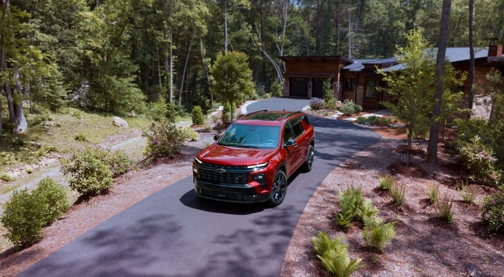 A red 2025 Chevy Traverse for sale near San Antonio parked on a driveway.