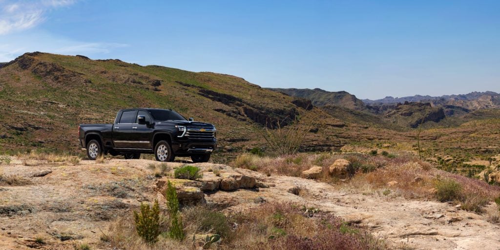 A black 2025 Chevy Silverado 2500 HD parked on a cliff.