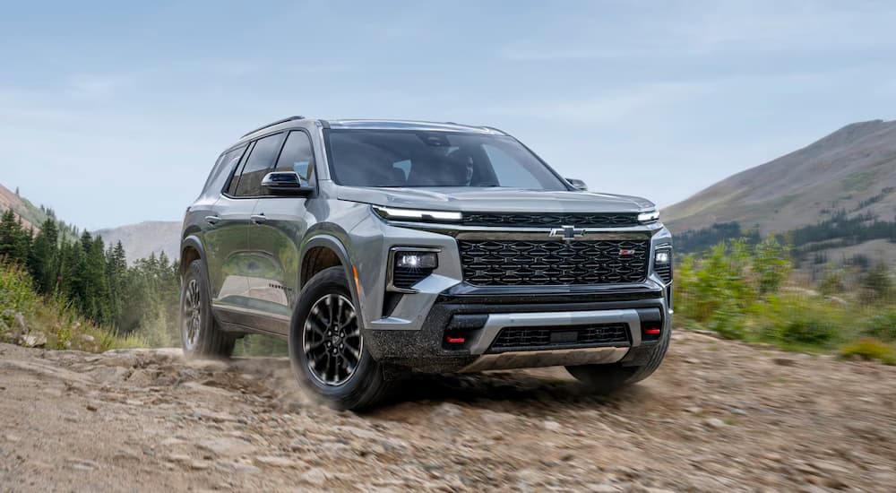 A silver 2025 Chevy Traverse off-roading on a trail