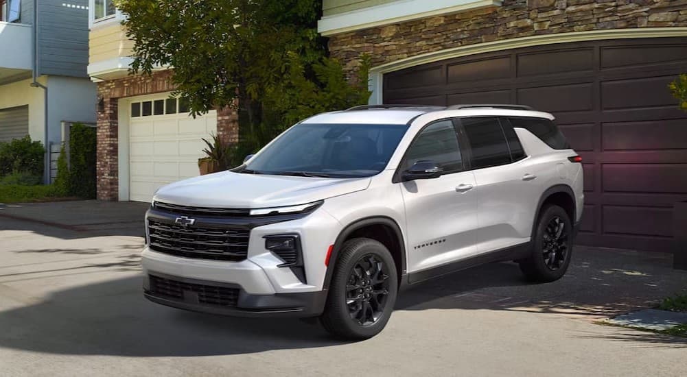 A white 2025 Chevy Traverse parked in a driveway.